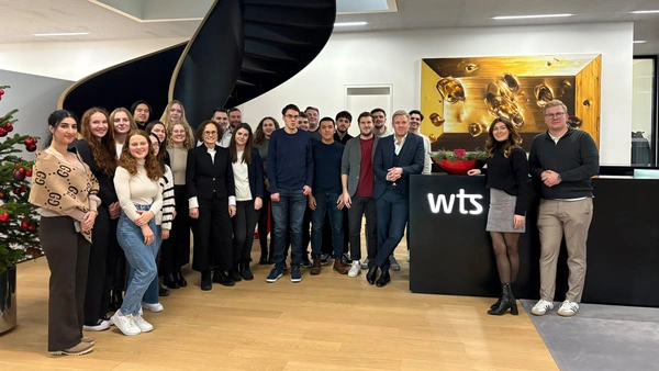 A group photo in the WTS Advisory company building.