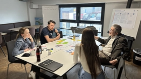 Four people at the meeting table