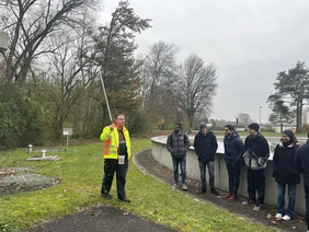 Students look at water sample in the sewage treatment plant