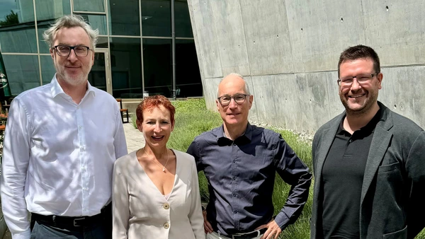 Three men and a woman on the campus of THI Ingolstadt